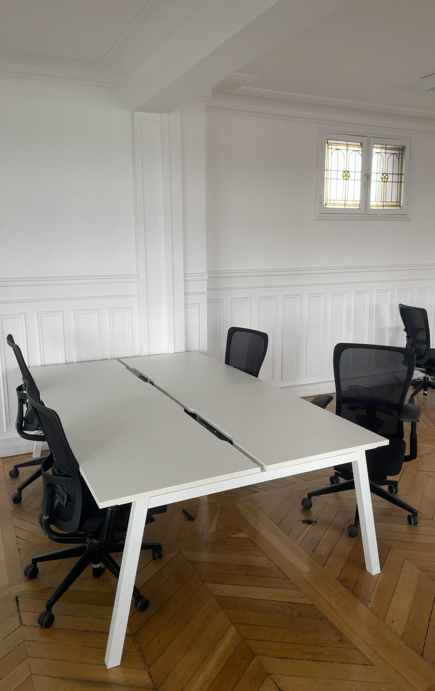 Bench bureau reconditionné avec chaises ergonomiques en open space lumineux.